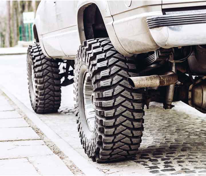 white truck with raised suspension